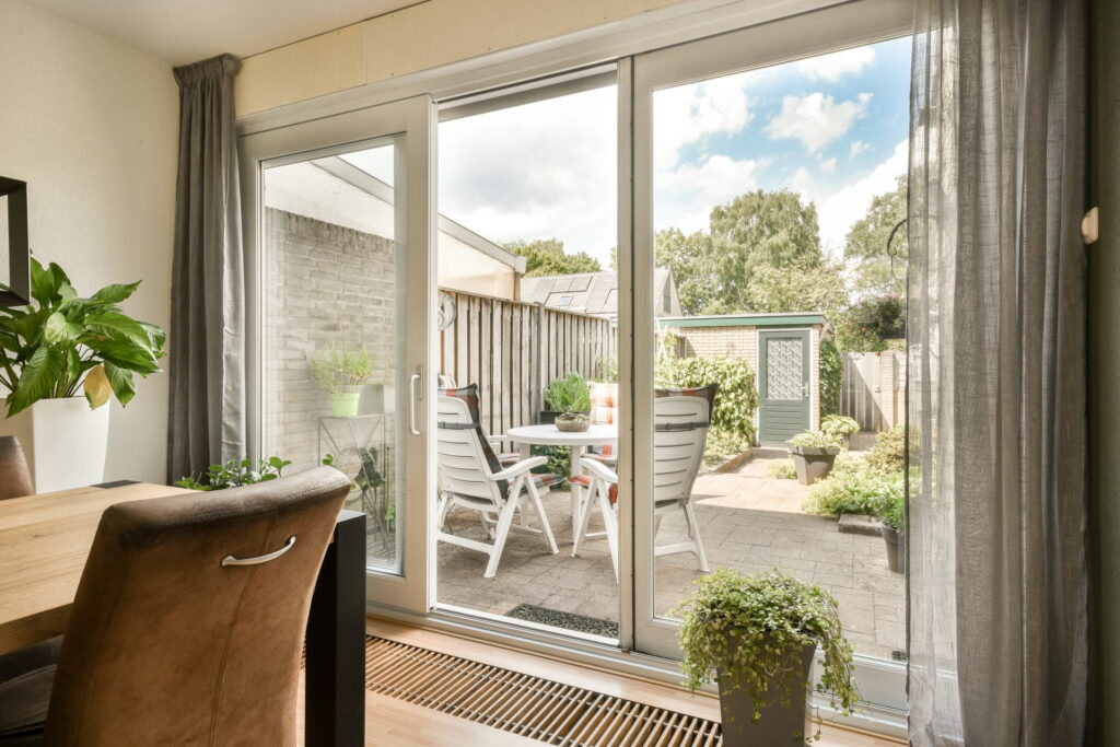 a-living-room-with-large-windows-and-a-patio-with-2023-11-27-05-34-19-utc (1)